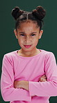 Crossed arms, upset and face of child in studio with disappointment, bad mood or attitude. Unhappy, angry and portrait of girl kid by green background with naughty sulking, grumpy or brat tantrum.