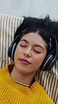 Above, woman and relax on bed with headphones, streaming and listening to music for peace. Person, rest and eyes closed at house with sound, playlist audio and musical subscription for stress relief