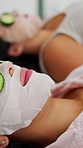 Unwind, cucumber and girl friends with face mask in home for skincare, beauty and wellness on weekend. Relax, cosmetic and women with fruit for cleansing pores, health or facial treatment in house.