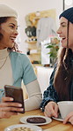 Phone, friends and women laugh in cafe for bonding, show post or social media message with smile. Mobile, happy people and talking in coffee shop for gossip, share meme or funny joke on weekend