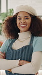 Face, happy and woman at cafe with crossed arms for welcome, friendly service and about us. Portrait, hospitality and person with laugh, positive attitude and pride for coffee shop or restaurant