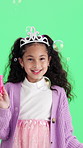 Face, bubbles and girl in costume with green screen for playing, pretend and fantasy. Childhood, portrait and happy child with wand, crown and toys for fun, games and magic on chromakey background