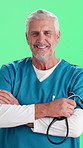 Face, man and surgeon with confidence, stethoscope and heart health on green background. Studio, mature person or happy nurse with arms folded for medical, career integrity or pulmonary wellness