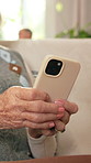 Typing, phone and hands of senior woman in home for texting, email and reading blog on mobile app. Technology, retirement and elderly person on cellphone with chatting on website in apartment.