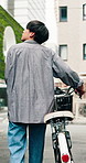 Travel, back and man with bike in town for morning commute, adventure and journey. Explore, cycling and Japanese person with bicycle for urban trip, sustainable or eco friendly transport outdoors