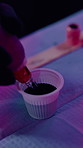 Tattoo, parlor and hands of person with ink cap to prepare for artwork, design and body modification. Shop, aesthetic and artist with machine, pigment and tools for permanent art, service and start