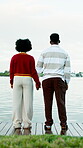 Holding hands, back and love with couple on boardwalk for romantic vacation, date and support. Lake view, connection and commitment with man and woman outdoor for adventure, holiday and care