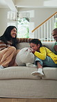 Jump, laughing and sofa with interracial family in home together for playful connection. Excited daughter, funny father and happy mother in apartment for energy, group bonding or joy on weekend