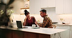Couple, conversation and paperwork in home with laptop, financial planning or mortgage loan proposal. Married, mature people and talk in kitchen with documents, debt financing and check credit score.