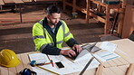 Creative, carpenter and man with laptop in workshop, research and planning for furniture production. Woodworking, blueprint and person with technology, above and inventory management in warehouse