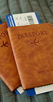 Boarding, passport and ticket on bed for flight, international travel and booking for holiday. Empty room, visa or document for global journey, transport receipt and departure information for getaway