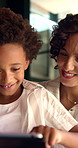 Happy mom, elearning and child with tablet in home, knowledge and development with ebook on website. Family, smile and African woman with son, childcare and online education with technology in house