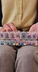 Hands, pill box and weekly with old person in home living room for chronic medication. Organization, sorting and tablets with senior in apartment for healthcare, pharmaceuticals or retirement