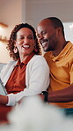 Laughing, couple and chill with tablet in lounge, entertainment and watching comedy on break in home. Interracial, relationship and mature people with technology, happy and funny movies in house