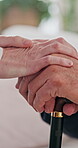 Cane, old man and person holding hands in house for support, empathy and help in retirement. Senior care, people and walking stick with gesture for hope, assistance and mental health in nursing home