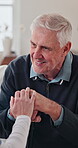 Cane, holding hands and old man laughing with nurse in home living room for good news. Funny, support and walking stick of happy senior person with caregiver for consulting, feedback or retirement