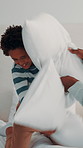 Break, pillow fight and playing with African boy in bedroom for bonding or family fun on holiday. Energy, father and happy son on bed in home for affection, cheerful activity or playful love