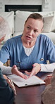 Clipboard, explain and healthcare for old couple with nurse in living room of retirement home. Checklist, documents and form with caregiver speaking to senior people for advice or medical consulting