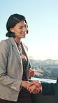 Handshake, rooftop and woman with client for meeting, show property or real estate deal in city. Realtor, shake hands and greement for urban development, business district or sale outdoor on building