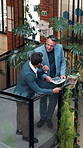 Men, talk and tablet in office with sustainable business, go green project update and manager review. Above, people and discussion in workplace with tech, eco friendly campaign feedback and advice.