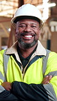 Crossed arms, black man and face of construction worker on site with confidence for building repairs. Happy, about us and portrait of mature civil engineer with pride for maintenance or renovation.