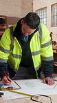 Blueprint, man and checklist in carpentry workshop for material list, verify design or writing. Shopfitting, carpenter and floor plan with clipboard for cabinetry notes, production schedule or trade