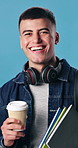 Happy, face and man in studio for university, college and textbooks for learning and studying. Smile, portrait and student with books, backpack and coffee for education, knowledge and blue background