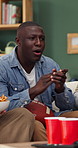 Watching tv, man and friends with applause for american football, team goal or winning with snacks. Sport fans, happy people or live streaming event in home with celebration, game success or clapping