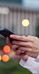 Hands, phone and typing outdoor with network connection, city news or social media post by space. Bokeh, app and person search on website, internet or digital platform for communication at night