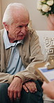 Senior man, talk and therapy session with psychologist, notes and mental health evaluation with info. Therapist, consultation and elderly person with depression, writing and assessment with clipboard