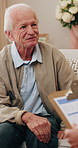 Happy, senior man and talk with psychologist in office, therapy session and mental health evaluation. Therapist, consultation and elderly person with smile, discussion and assessment with clipboard