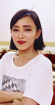 Japanese woman, face and arms crossed with drum sticks in class for taiko tradition, culture or practice. Portrait, asian musician and person with pride for music lesson, sound or percussion art