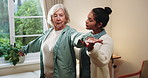 Physiotherapist, support and old woman in clinic with stretching, rehabilitation or advice for healing. Senior person, talk and healthcare worker help with arm exercise, injury recovery and wellness.