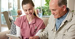Elderly, nurse and healthcare with tablet in retirement home for medical schedule or activities. Female person, health worker or caregiver talking with man or technology for senior care app in house