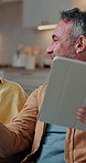 Relax, tablet and talking with man on sofa in home living room for bonding, sharing or streaming. App, conversation and scrolling with happy mature couple in apartment for break or connection