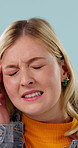 Woman, stress and headache in studio from burnout, health issue and frustration with medical problem. Unhappy, female person and sick with migraine, fatigue and pain with pressure on blue background