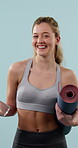 Face, studio and happy woman with yoga mat for fitness, exercise and wellness with water bottle. Portrait, female person and laugh in sports bra for health, workout routine or gear on blue background
