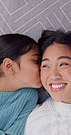 Kiss, face and child with mom on floor for bonding, connection and loving relationship in home. Portrait, family and above of girl with mother, smile and happy with affection, support and trust