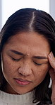 Stress, headache and Asian woman in home with migraine, head pain and strain for medical crisis. House, health and person with pressure, tension and massage temples for fatigue, tired or burnout