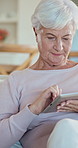 Smile, tablet and senior woman in house with social media, blog or online newsletter in living room. Happy, digital technology and elderly person in retirement with communication on app in home.