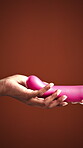 Giving, sex toy and hands with object for pleasure, studio background and erotic tool for self care. Mockup space, sexual wellness and people with sensual equipment, personal intimacy and stimulation