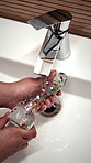 Washing, sink and hands of person with sex toy for hygiene, germ prevention and maintenance. Bathroom, home and woman with soap, water and sensual accessory for wellness, cleaning and disinfection