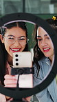 Friends, phone and live stream in home with ring light, talk and shock for influencer collaboration. Happy, gen z women and content creation with tech, social media and surprise for online broadcast.