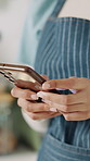 Hands, barista and phone with typing for small business, communication or online order in cafe. Waitress, tech and notification for takeaway or delivery with customer service, social media or review