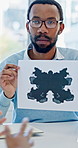 Psychology, man and inkblot test in office for consultation, evaluation or mental health assessment. Psychologist, rorschach exam or client in practice for therapy with method to expose hidden traits