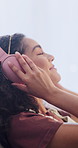Headphones, relax and woman in home with audio, smile and streaming service on weekend break. Music, happy person and listening to favorite song, sound or playlist for peace on radio at apartment