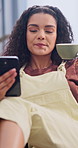 Coffee, phone and woman on sofa in house with peace, texting or calm morning on weekend. Happy, drinking and person with warm beverage and cellphone in living room for chatting or caffeine break.