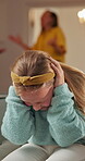 Fight, parents and girl in house with fear, anxiety and marriage conflict in toxic home. Sad, argument and child on couch with frustration, relationship issue and unhappy kid with family dispute.