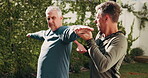 Fitness, senior man and stretching with personal trainer, wellness and exercise routine in backyard. Instructor, talk and warm up with elderly person for health, physical activity or workout at house
