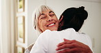 Happy, hug and caregiver with senior woman in home for support, comfort or good news on treatment. Smile, healthcare and medical worker embracing elderly patient for trust at consultation in house.